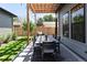 Inviting backyard patio shows a dining table and seating under a wood pergola and string lights at 3149 W 35Th Ave, Denver, CO 80211