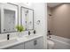 Elegant bathroom with double sink vanity, sleek black fixtures, and a separate bathtub and toilet area at 3149 W 35Th Ave, Denver, CO 80211