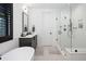 Modern bathroom featuring sleek glass shower, soaking tub, and stylish fixtures at 3149 W 35Th Ave, Denver, CO 80211
