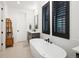 Serene bathroom featuring a freestanding tub, dark fixtures, and natural light at 3149 W 35Th Ave, Denver, CO 80211