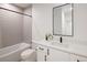 This bathroom features a bathtub with grey tiles, toilet, and a sleek white sink with black hardware at 3149 W 35Th Ave, Denver, CO 80211