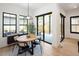 Dining area with a round wooden table, modern chairs, and sliding glass doors to the outside at 3149 W 35Th Ave, Denver, CO 80211