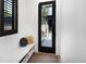 Bright entryway with bench seating, storage baskets, and a view of the outdoor space at 3149 W 35Th Ave, Denver, CO 80211