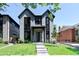 Charming gray two-story house with modern design, green lawn and landscaped surroundings at 3149 W 35Th Ave, Denver, CO 80211