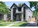 Contemporary two-story home featuring a well-manicured lawn and modern architectural details at 3149 W 35Th Ave, Denver, CO 80211
