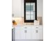 Bright white cabinets with black hardware and modern stainless steel appliances at 3149 W 35Th Ave, Denver, CO 80211