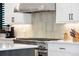 Kitchen details: Stainless steel hood and tiled backsplash enhance modern appeal at 3149 W 35Th Ave, Denver, CO 80211