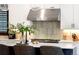 Bright kitchen island boasts pendant lights and seating, complemented by a stainless steel range at 3149 W 35Th Ave, Denver, CO 80211
