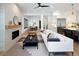 Open-concept living room featuring a fireplace, modern furnishings, and hardwood floors at 3149 W 35Th Ave, Denver, CO 80211