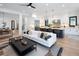 Open-concept living room with a modern kitchen, stylish seating, and great natural light at 3149 W 35Th Ave, Denver, CO 80211