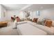 Spacious living area featuring a plush sectional sofa, dining area, staircase, and large windows at 3149 W 35Th Ave, Denver, CO 80211