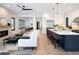 Bright living room features an open floor plan with modern furniture and fireplace, flowing into a spacious kitchen at 3149 W 35Th Ave, Denver, CO 80211