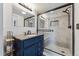 Bathroom featuring sleek glass shower and updated vanity at 3300 W 2Nd Ave, Denver, CO 80219