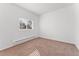 Bright bedroom features neutral walls, plush carpeting, and natural light from the window at 3300 W 2Nd Ave, Denver, CO 80219