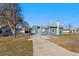 Cozy blue single-story home features a spacious front yard and driveway access at 3300 W 2Nd Ave, Denver, CO 80219