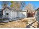 Exterior view of a detached garage with concrete pathway in backyard setting at 3300 W 2Nd Ave, Denver, CO 80219