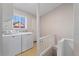 Bright laundry room with modern appliances, a window, and access to outside at 3300 W 2Nd Ave, Denver, CO 80219