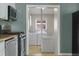 View of laundry room and appliances from kitchen at 3300 W 2Nd Ave, Denver, CO 80219