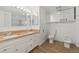 Bright bathroom featuring a double vanity, spacious mirror, toilet, and bidet at 1777 Larimer St # 608, Denver, CO 80202