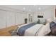 Bright bedroom with hardwood floors, an accent rug, and double doors to the exterior at 1777 Larimer St # 608, Denver, CO 80202