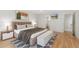 Cozy primary bedroom featuring soft decor, hardwood floors, and ensuite bathroom at 1777 Larimer St # 608, Denver, CO 80202