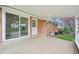 Spacious back patio with sliding glass doors and a covered roof at 8307 E Lehigh Dr, Denver, CO 80237