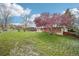 Large, lush backyard with mature trees and a well-maintained lawn at 8307 E Lehigh Dr, Denver, CO 80237