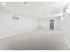 Unfurnished basement area with carpet, multiple windows and a doorway at 8307 E Lehigh Dr, Denver, CO 80237