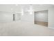 Finished basement with neutral carpet and an entrance to a room with wood flooring at 8307 E Lehigh Dr, Denver, CO 80237