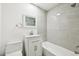 Bathroom with updated vanity, shower, and toilet at 8307 E Lehigh Dr, Denver, CO 80237