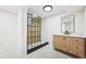 Bathroom features glass enclosed shower and modern vanity at 8307 E Lehigh Dr, Denver, CO 80237
