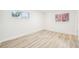 Neutral bedroom featuring wood floors and bright windows at 8307 E Lehigh Dr, Denver, CO 80237