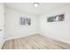 Bright bedroom features wood floors and white trim at 8307 E Lehigh Dr, Denver, CO 80237
