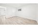 Light bedroom features wood floors and a bright window at 8307 E Lehigh Dr, Denver, CO 80237