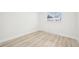 A light-filled bedroom with light-colored floors and a view of the outdoors at 8307 E Lehigh Dr, Denver, CO 80237