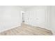 Bedroom with hardwood flooring, neutral paint, and white doors at 8307 E Lehigh Dr, Denver, CO 80237