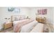 Serene bedroom featuring neutral tones, light wood accents, and great natural light from two windows at 8307 E Lehigh Dr, Denver, CO 80237