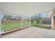 Covered back patio with railing overlooking a fenced yard at 8307 E Lehigh Dr, Denver, CO 80237
