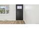 Stylish front door with decorative glass and modern hardware, complemented by new light-colored flooring at 8307 E Lehigh Dr, Denver, CO 80237