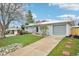 Inviting single-Gathering home features a well-manicured lawn, a driveway, and an attached garage at 8307 E Lehigh Dr, Denver, CO 80237