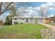 Charming single-story home featuring a well-maintained lawn and a driveway leading to an attached garage at 8307 E Lehigh Dr, Denver, CO 80237