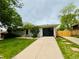 Charming one-story home with a well-maintained front yard, a new garage door, and attractive landscaping at 8307 E Lehigh Dr, Denver, CO 80237