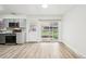 Bright kitchen with grey cabinets, stainless appliances and door to the backyard at 8307 E Lehigh Dr, Denver, CO 80237