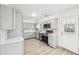 Updated kitchen with gray cabinets, quartz counters, and stainless steel appliances at 8307 E Lehigh Dr, Denver, CO 80237