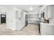 A stylish kitchen with white counters, grey cabinets and stainless steel appliances at 8307 E Lehigh Dr, Denver, CO 80237