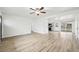 Bright and airy living room with neutral walls, ceiling fan, and durable wood-look flooring throughout at 8307 E Lehigh Dr, Denver, CO 80237
