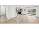 Living room featuring recessed lights, wood-look flooring, with an open view of the kitchen at 8307 E Lehigh Dr, Denver, CO 80237