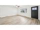 Bright living room featuring hardwood floors, freshly painted walls, and a large window at 8307 E Lehigh Dr, Denver, CO 80237