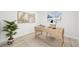 Bright home office features a contemporary desk, stylish decor, and a view to the neighborhood at 8307 E Lehigh Dr, Denver, CO 80237