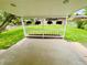 Covered patio offers outdoor living space with views of the lush, green backyard at 8307 E Lehigh Dr, Denver, CO 80237